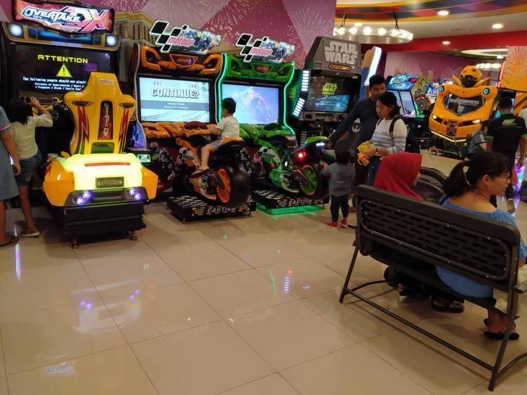 children playing games at arcade at trans studio mall